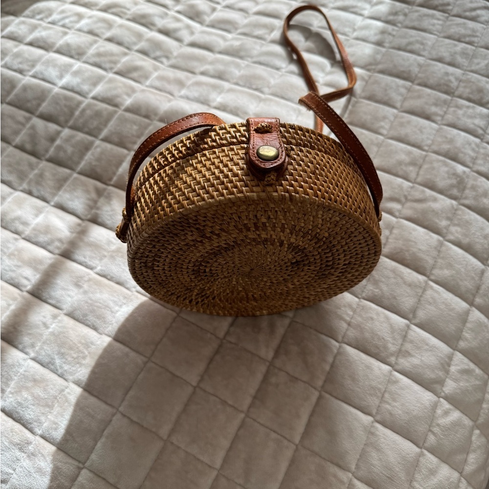 Cute cross-body wicker bag with snap closure.